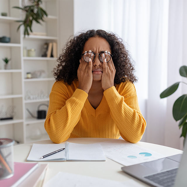 woman rubbing eyes