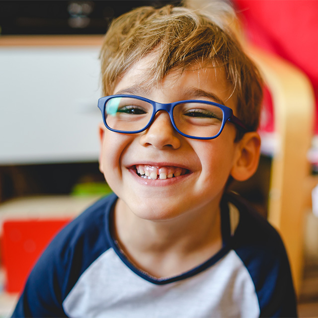 smiling boy with glasses